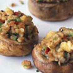 A close up of stuffed mushrooms on a plate